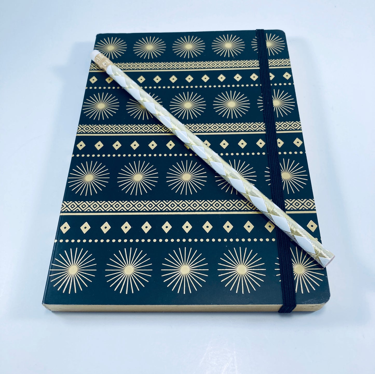 Black bound journal features starbursts and diamonds accented in gold.  A great addition to any desk, bag, backpack, or office.  